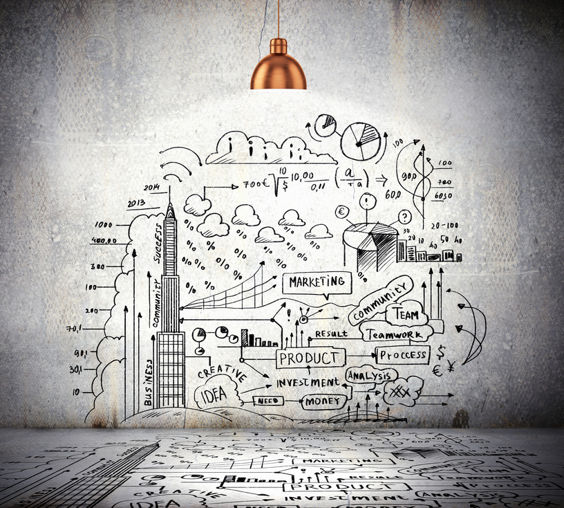 Drawn business plan on wall illuminated by lamp above