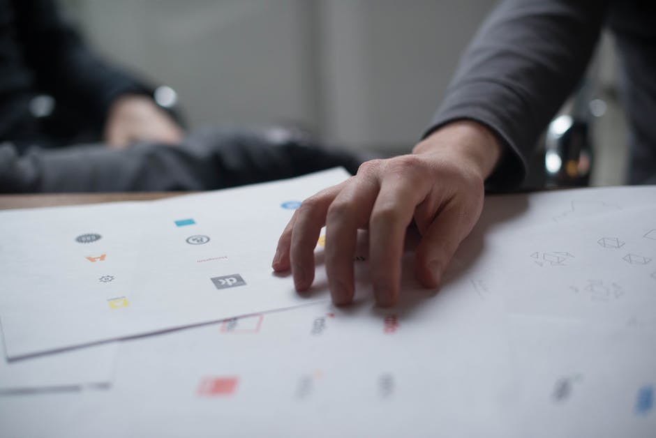 Designer pouring over financial logos ideas