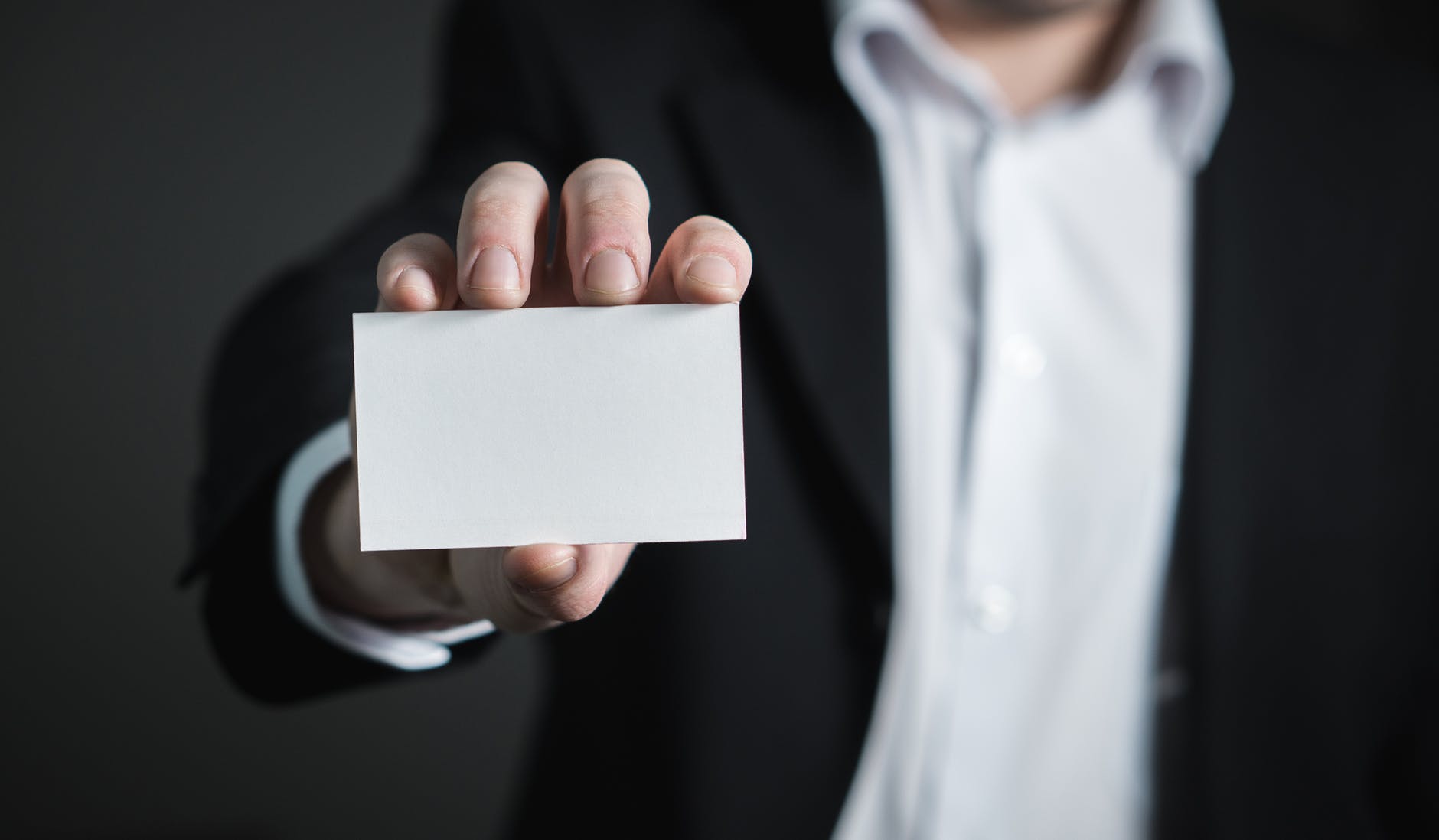 Man showing blank card to the screen, illustrating declining trends in digital marketing for financial websites
