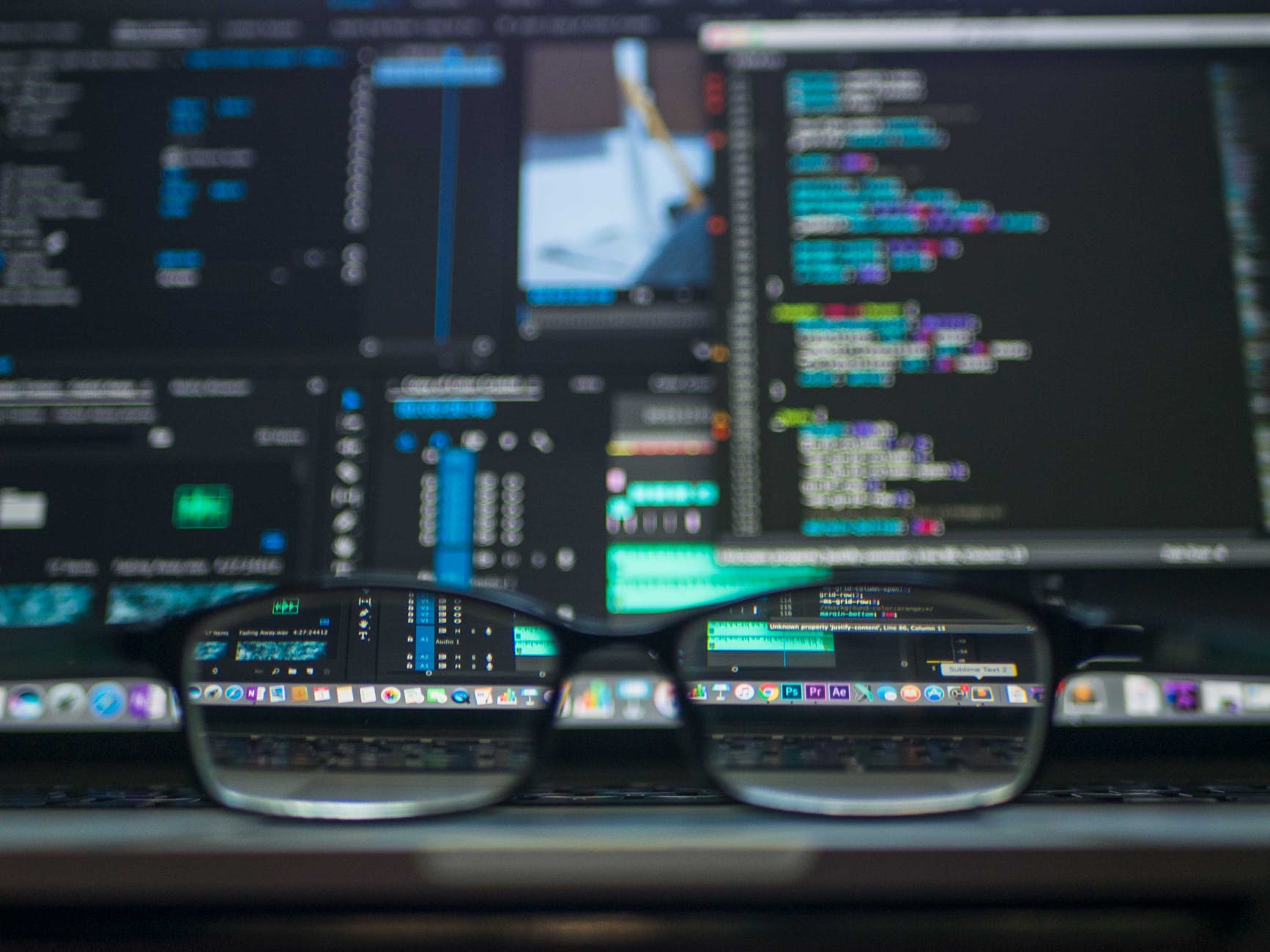 glasses on a computer desk, showing gdpr and financial websites