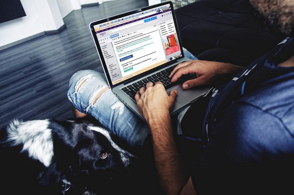Man engaged in email financial marketing on a laptop