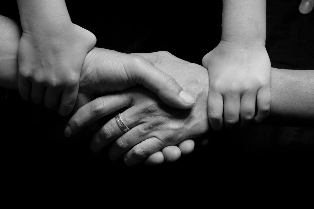 Hands grasped together, illustrating trust in websites for financial advisers.