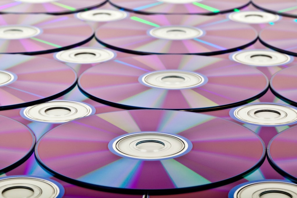 Copies of CDs on top of each other, symbolising duplication in financial marketing 