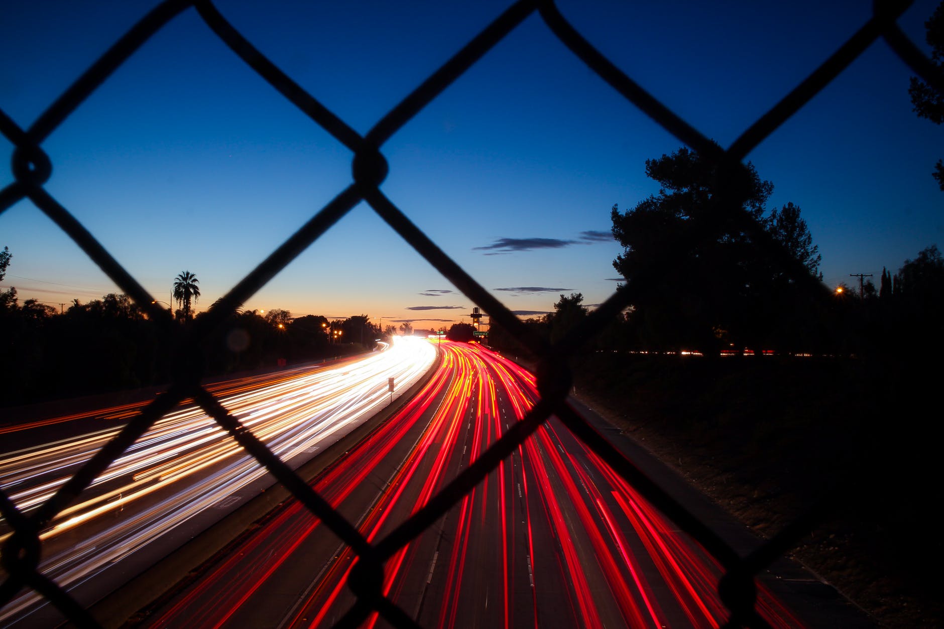 Picture of a fence overlooking a night-time highway, illustrating backlink building in SEO